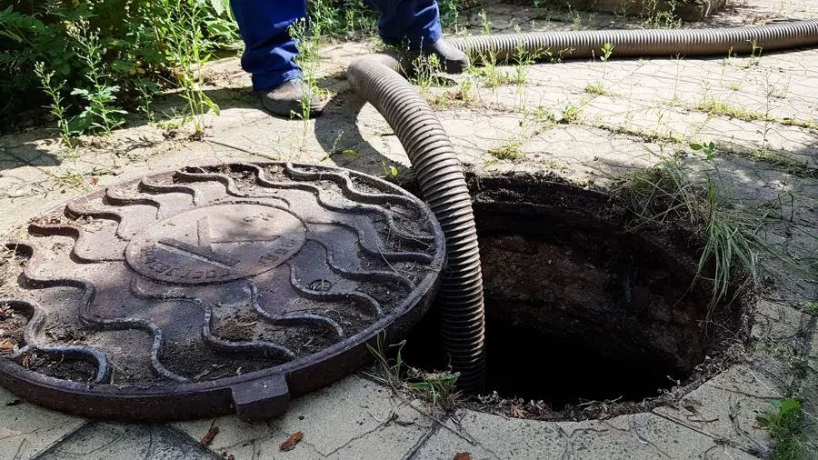 Standing water being pumped from the crawl space of a Pomona, CA home