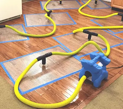 Air movers and dehumidifiers drying the structure of a Pomona, CA home